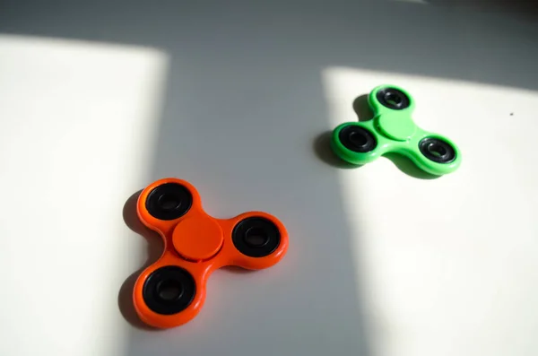 Fidget finger spinner stress, anxiety relief toy on table