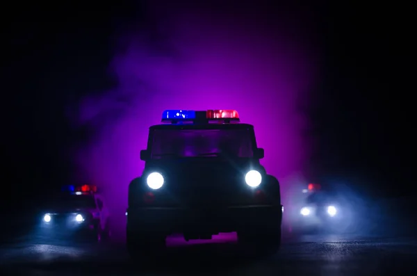 Geschwindigkeitsbeleuchtung von Polizeiwagen in der Nacht auf der Straße. Polizeiautos im Nebel unterwegs. Selektiver Fokus. Verfolgungsjagd — Stockfoto