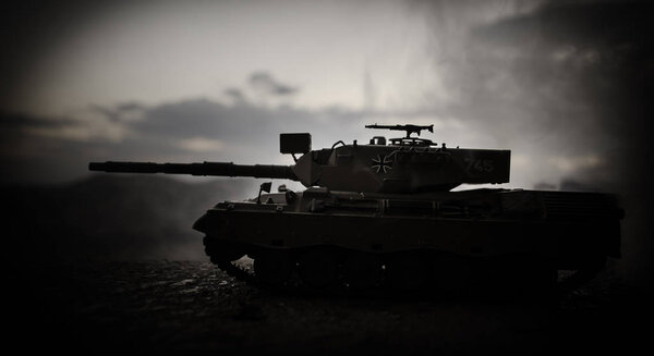 War Concept. Military silhouettes fighting scene on war fog sky background, World War German Tanks Silhouettes Below Cloudy Skyline At night. Attack scene. Armored vehicles. Tanks battle scene