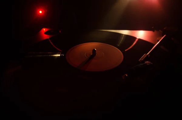 ターン テーブル ビニール レコード プレーヤー。ディスク ジョッキーのレトロなオーディオ機器。Dj ミックス ・音楽を再生するためのサウンド テクノロジー。煙と火の背景の書き込みに対して再生されてビニール レコード。ヴィンテージ — ストック写真