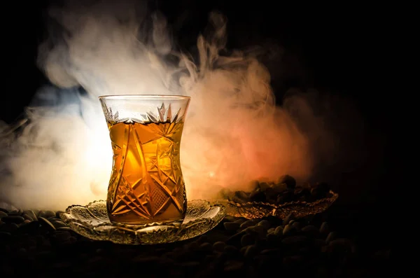 Té turco de Azerbaiyán en vidrio tradicional y olla sobre fondo negro con luces y humo. Copa tradicional Armudu —  Fotos de Stock