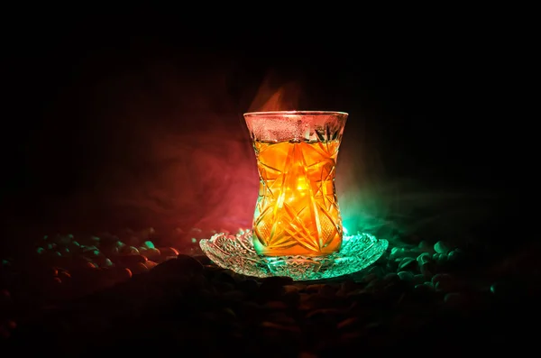 Té turco de Azerbaiyán en vidrio tradicional y olla sobre fondo negro con luces y humo. Copa tradicional Armudu —  Fotos de Stock