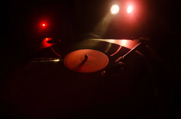 Gravador de vinil giratório. Equipamento de áudio retrô para disc jockey. Tecnologia de som para DJ para misturar e reproduzir música. Registro de vinil sendo jogado contra queima de fundo de fogo com fumaça. Vindima — Fotografia de Stock