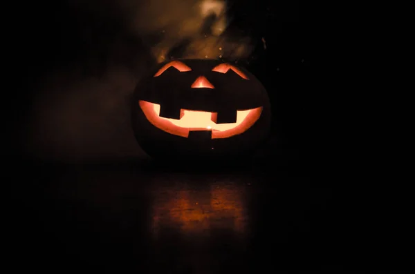 Halloween - old jack-o-lantern on black background. Closeup of scary halloween pumpkins — Stock Photo, Image