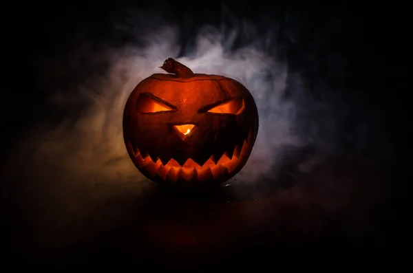Halloween - old jack-o-lantern on black background. Closeup of scary halloween pumpkins — Stock Photo, Image