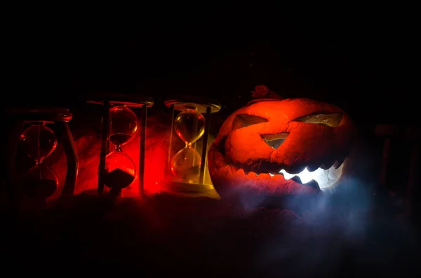 Homokóra. Halloween sütőtök fej jack lantern félelmetes gonosz arcok kísérteties holiday égő gyertya felett fa háttér. Halloween ünnepek art design, ünnep. — Stock Fotó