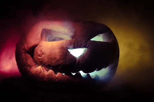 Halloween pumpkins smile and scrary eyes for party night. Close up view of scary Halloween pumpkin with eyes glowing inside at black background — Stock Photo, Image