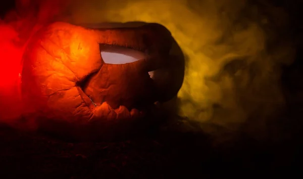 Le zucche di Halloween sorridono e gli occhi scuri per la notte di festa. Vista da vicino della spaventosa zucca di Halloween con gli occhi che brillano all'interno su sfondo nero — Foto Stock