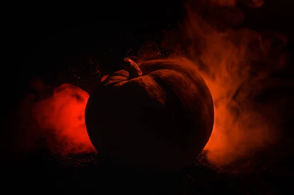 Halloween pumpkins smile and scrary eyes for party night. Close up view of scary Halloween pumpkin with eyes glowing inside at black background — Stock Photo, Image