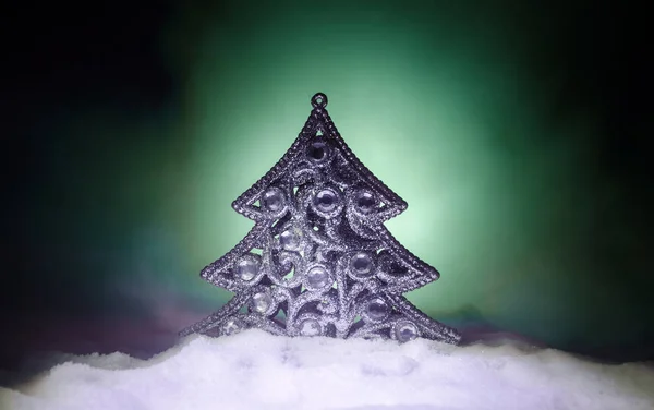 Χριστουγεννιάτικο φόντο με το χιονισμένο έλατο. Χιόνι κάλυψε χριστουγεννιάτικο δέντρο ξεχωρίζει έντονα εναντίον τους σκούρους τόνους του μπλε (ή πράσινο) της σκηνή χιόνι που καλύπτει αυτό. Τονισμένο σκούρο φόντο — Φωτογραφία Αρχείου