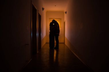 Kabine kapılar ve korkunç korku adam ile farklı pozlar ayakta silüeti ışıklarla karanlık koridor.