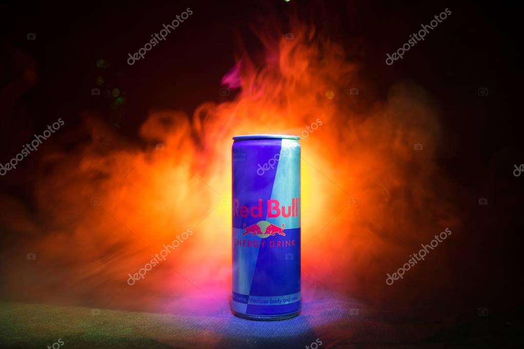 BAKU, AZERBAIJAN - January 13, 2018: Red Bull classic 250 ml can on dark toned foggy background. Red Bull is an energy drink sold by Austrian company Red Bull GmbH