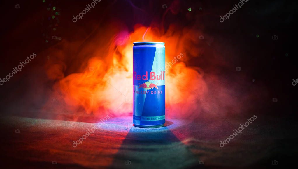 BAKU, AZERBAIJAN - January 13, 2018: Red Bull classic 250 ml can on dark toned foggy background. Red Bull is an energy drink sold by Austrian company Red Bull GmbH