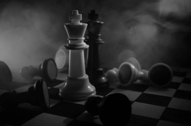 chess board game concept of business ideas and competition and strategy ideas concep. Chess figures on a dark background with smoke and fog. clipart