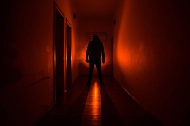 Kabine kapılar ve korkunç korku adam ile farklı pozlar ayakta silüeti ışıklarla karanlık koridor.