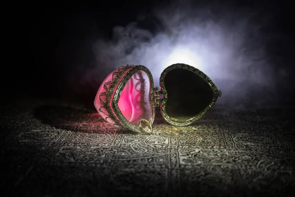 Caixão em forma de coração de prata vintage aberto velho para anéis de casamento no fundo de luz fumegante tonificado escuro. Valentine amor conceito . — Fotografia de Stock