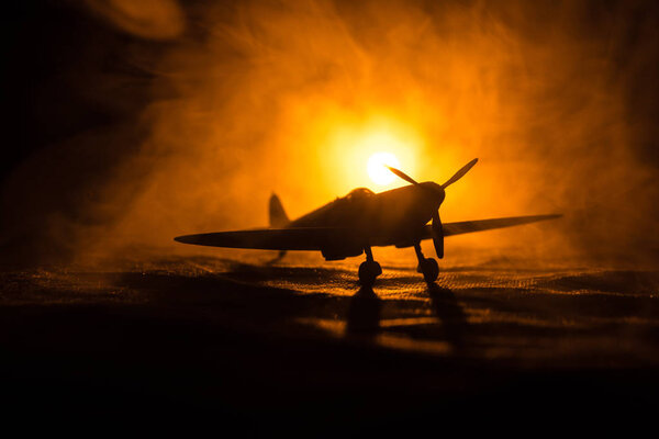 British jet-propelled model plane in possession. Dark orange fire background. War scene.