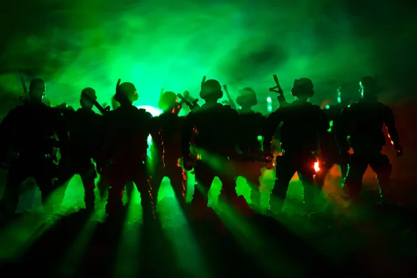War Concept. Military silhouettes fighting scene on war fog sky background, World War Soldiers Silhouettes Below Cloudy Skyline At night. Attack scene. Armored vehicles. Tanks battle.