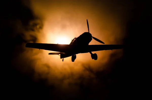 World war ii fighter plane at sunset or dark orange fire explosion sky. War scene. German figher at sky