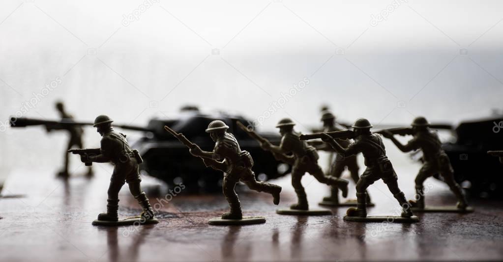 miniature toy soldiers and tank on board. Close up image of toy military at war.