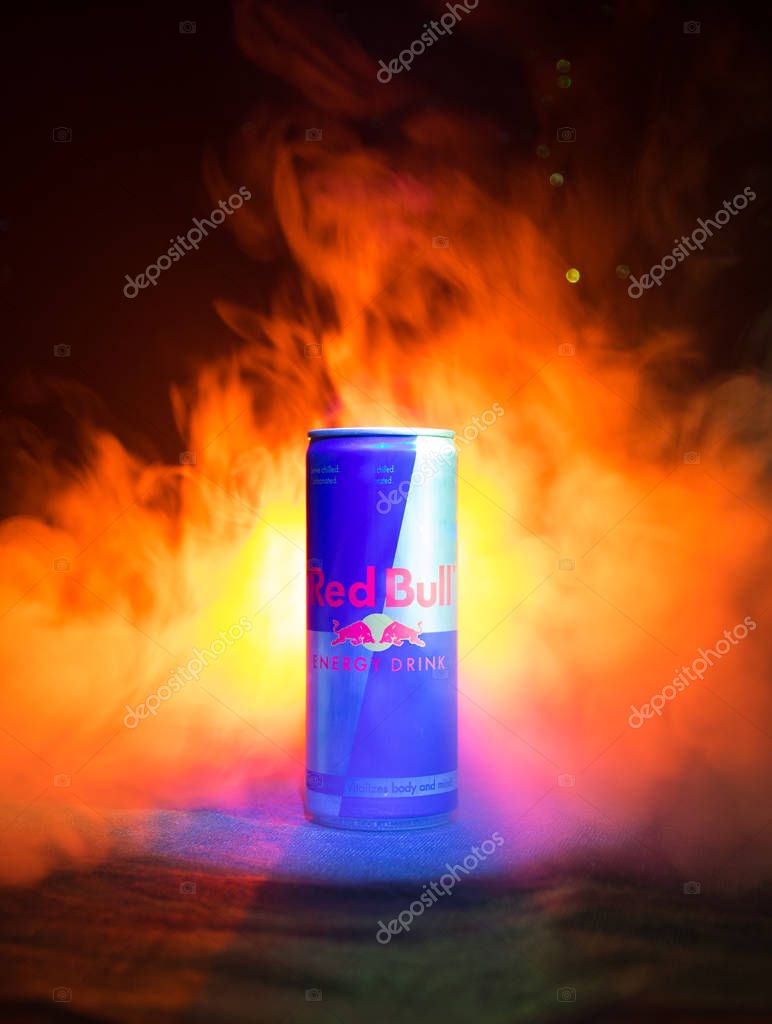 BAKU, AZERBAIJAN - January 13, 2018: Red Bull classic 250 ml can on dark toned foggy background. Red Bull is an energy drink sold by Austrian company Red Bull GmbH