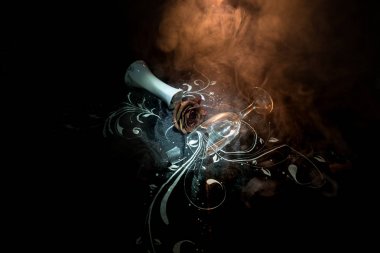 A wilting rose signifies lost love, divorce, or a bad relationship, dead rose on dark background with smoke clipart