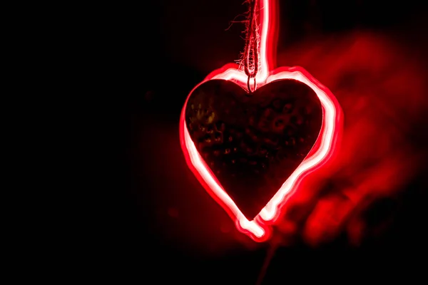 Golden Heart hangs on rope on dark toned smoky background and space for text. Valentine day concept. — Stock Photo, Image