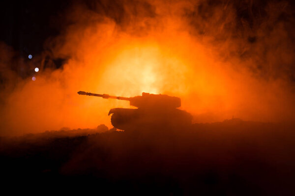 War Concept. Military silhouettes fighting scene on war fog sky background, World War German Tanks Silhouettes Below Cloudy Skyline At night. Attack scene. Armored vehicles.