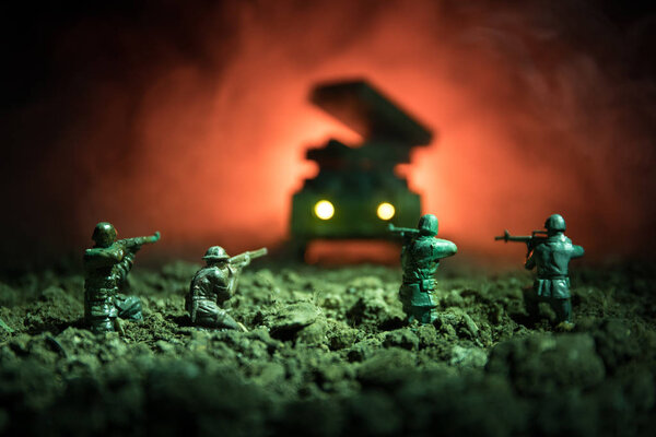 War Concept. Military silhouettes fighting scene on war fog sky background, World War Soldiers Silhouettes Below Cloudy Skyline At night. Attack scene. Armored vehicles. Tanks battle.