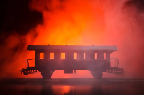 Train moving in fog. Ancient steam locomotive in night. Night train moving on railroad. orange fire background.