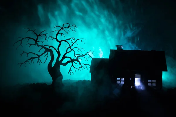Vieille maison avec un fantôme la nuit avec un arbre effrayant ou maison d'horreur hantée abandonnée dans un ciel brumeux tonique avec de la lumière. Ancien bâtiment mystique dans la forêt d'arbres morts. Concept Halloween . — Photo