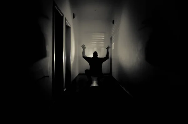 Couloir sombre avec portes d'armoire et lumières avec silhouette d'homme d'horreur effrayant debout avec différentes poses . — Photo