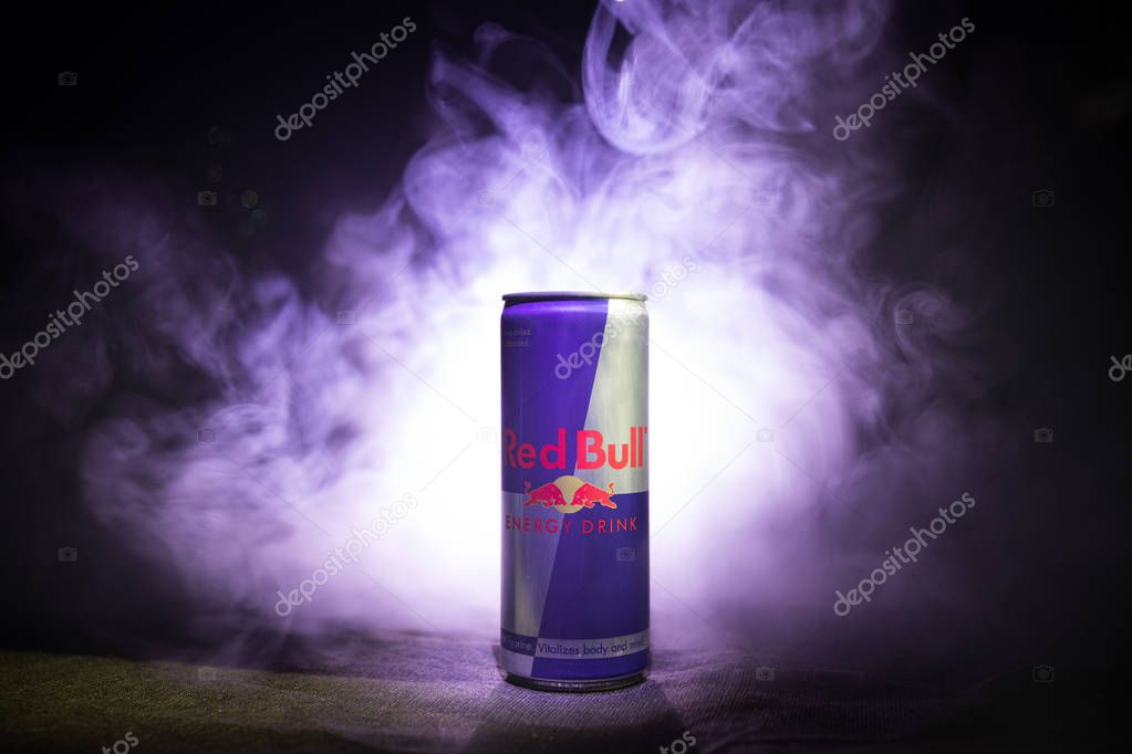 BAKU, AZERBAIJAN - January 13, 2018: Red Bull classic 250 ml can on dark toned foggy background. Red Bull is an energy drink sold by Austrian company Red Bull GmbH