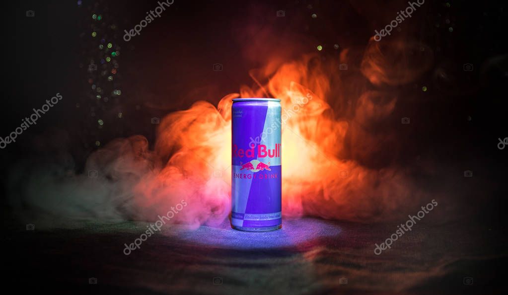 BAKU, AZERBAIJAN - January 13, 2018: Red Bull classic 250 ml can on dark toned foggy background. Red Bull is an energy drink sold by Austrian company Red Bull GmbH