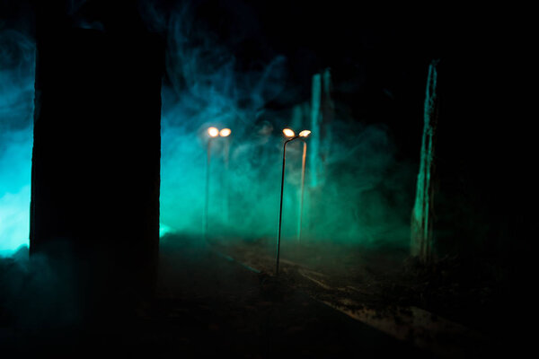 Empty street of burnt up city, flames on the ground and blasts with smoke in the distance. Apocalyptic view of city downtown as disaster film poster concept. City destroyed by war.