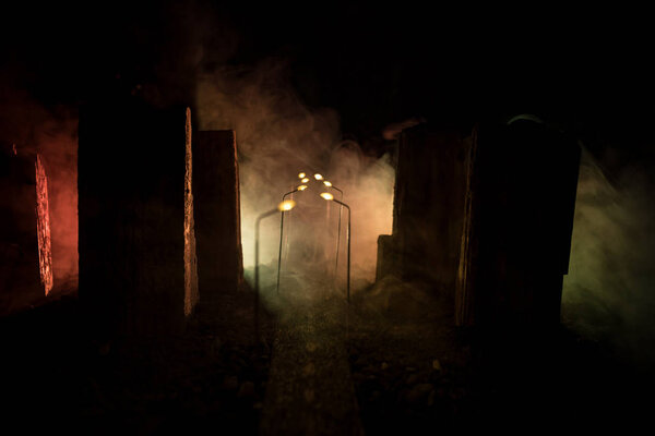 Empty street of burnt up city, flames on the ground and blasts with smoke in the distance. Apocalyptic view of city downtown as disaster film poster concept. City destroyed by war.