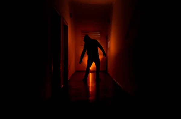 Dark corridor with cabinet doors and lights with silhouette of spooky horror man standing with different poses. — Stock Photo, Image
