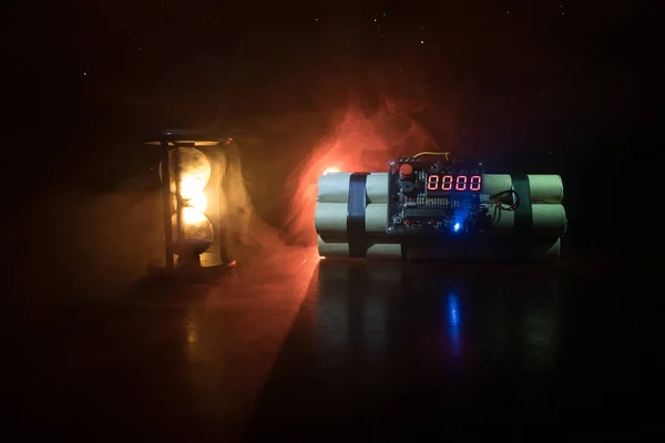 Изображение бомбы замедленного действия на темном фоне. Таймер отсчитывает время до детонации, освещаемой светом шахты, сияющим сквозь темноту. — стоковое фото
