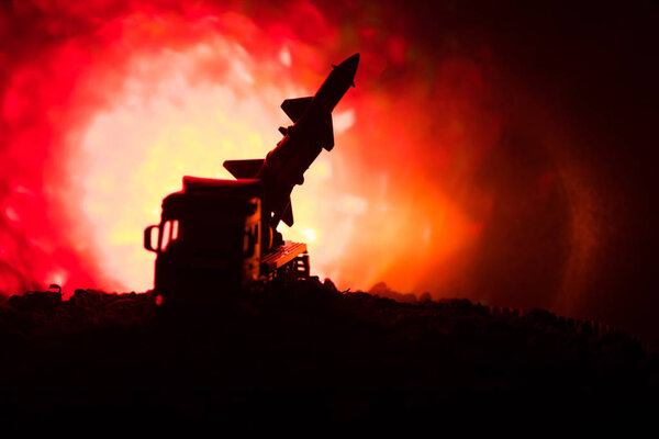 Rocket launch with fire clouds. Battle scene with rocket Missiles with Warhead Aimed at Gloomy Sky at night. Rocket vehicle on War Backgound.