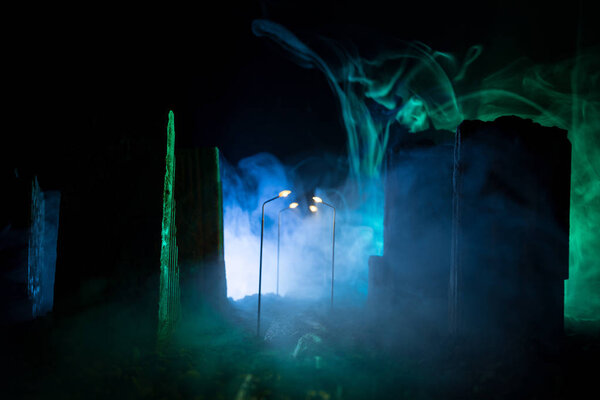 Empty street of burnt up city, flames on the ground and blasts with smoke in the distance. Apocalyptic view of city downtown as disaster film poster concept. City destroyed by war.