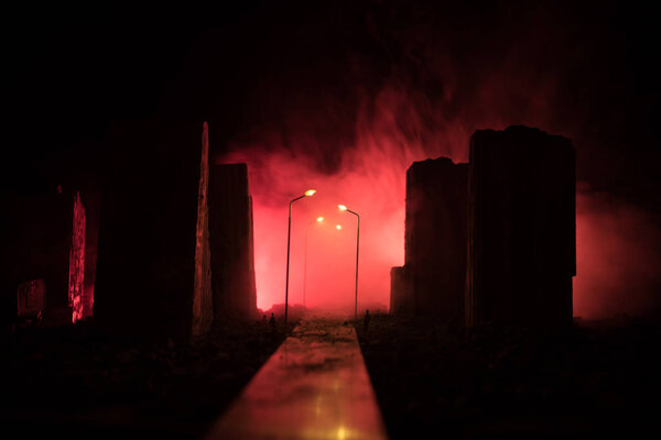 Empty street of burnt up city, flames on the ground and blasts with smoke in the distance. Apocalyptic view of city downtown as disaster film poster concept. City destroyed by war.