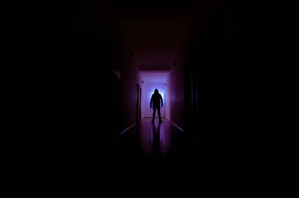 Dark corridor with cabinet doors and lights with silhouette of spooky horror man standing with different poses. — Stock Photo, Image