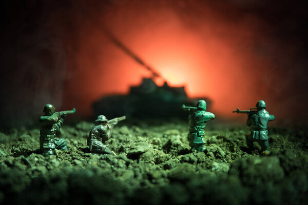 War Concept. Military silhouettes fighting scene on war fog sky background, World War Soldiers Silhouettes Below Cloudy Skyline At night. Attack scene. Armored vehicles. Tanks battle.