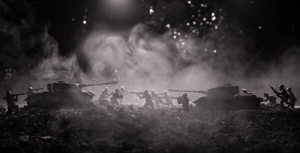 War Concept. Military silhouettes fighting scene on war fog sky background, World War Soldiers Silhouettes Below Cloudy Skyline At night. Attack scene. Armored vehicles. Tanks battle.