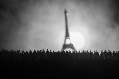 Silhouettes of a crowd standing at field behind the blurred foggy background. Revolution, people protest against government, man fighting for rights clipart