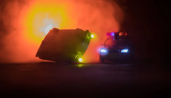 Toy BMW Police car chasing a Ford Thunderbird car at night with fog background. Toy decoration scene on table . Selective focus - 11 JAN 2018, BAKU AZERBAIJAN — Stock Photo, Image