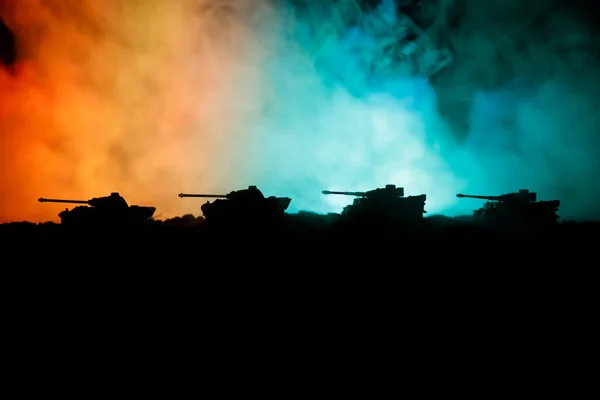 War Concept. Military silhouettes fighting scene on war fog sky background, World War German Tanks Silhouettes Below Cloudy Skyline At night. Attack scene. Armored vehicles. Tanks battle. Close up