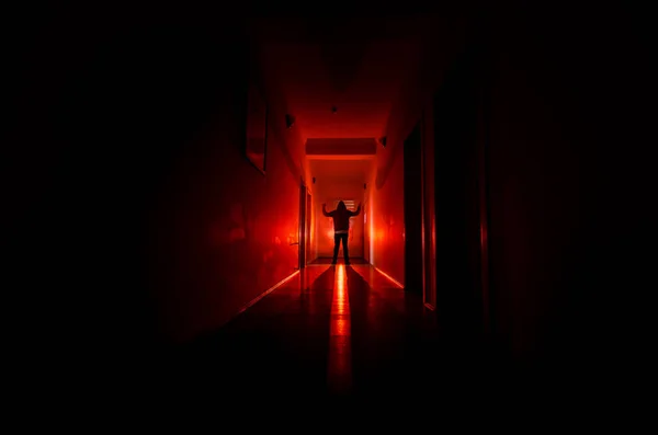 Dark corridor with cabinet doors and lights with silhouette of spooky horror man standing with different poses.