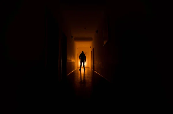 Dark corridor with cabinet doors and lights with silhouette of spooky horror man standing with different poses. — Stock Photo, Image