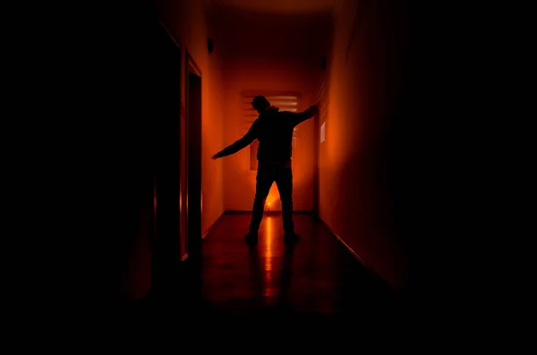 Dark corridor with cabinet doors and lights with silhouette of spooky horror man standing with different poses. — Stock Photo, Image